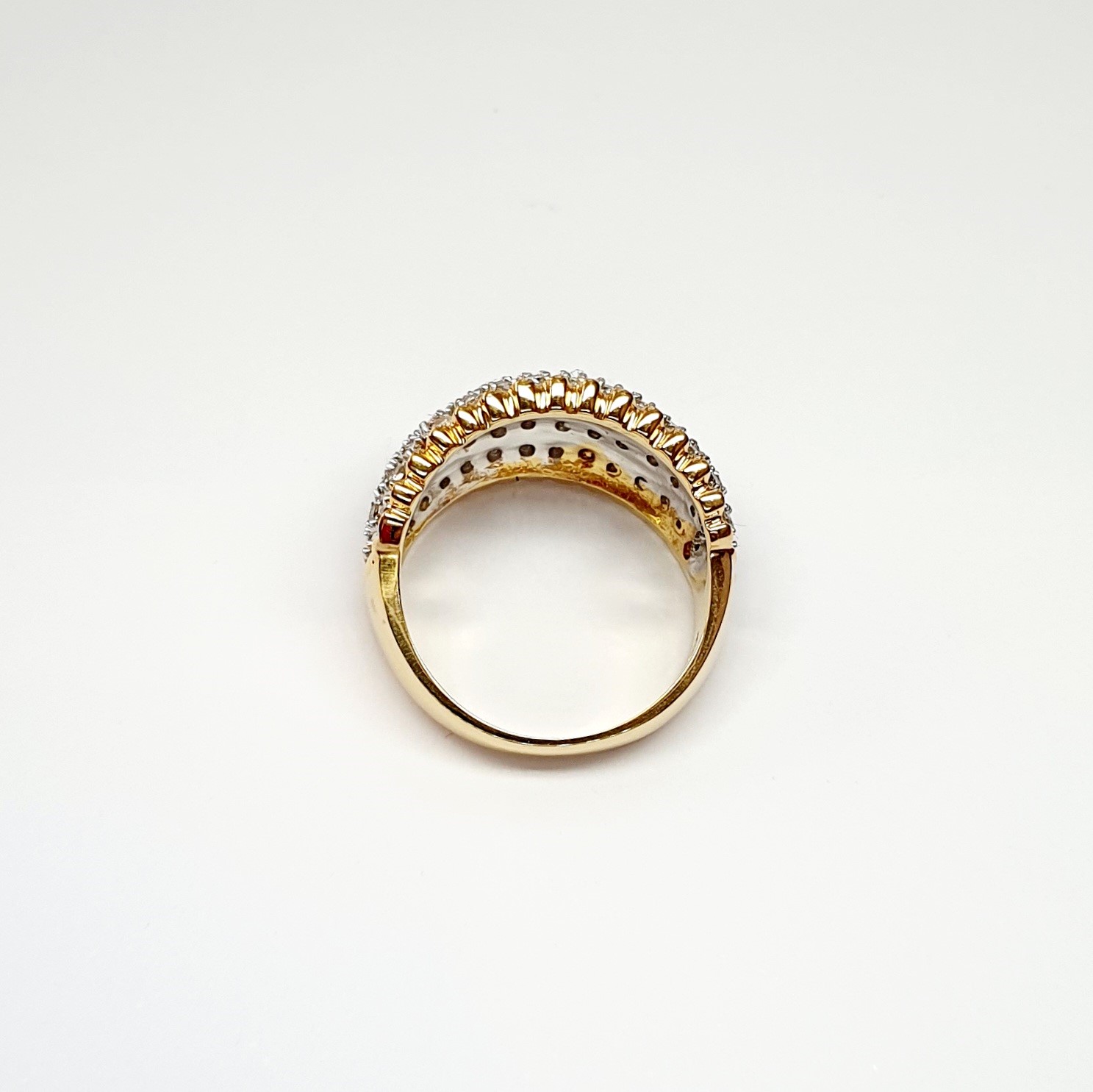 Bombay ring with Seventy round diamonds In a rhodium Pave setting, the total diamond weight is approx. one carat with 7.8 grams of 18ct yellow gold width at the top widest part is 13.6mm tapering to 3.6mm at the back