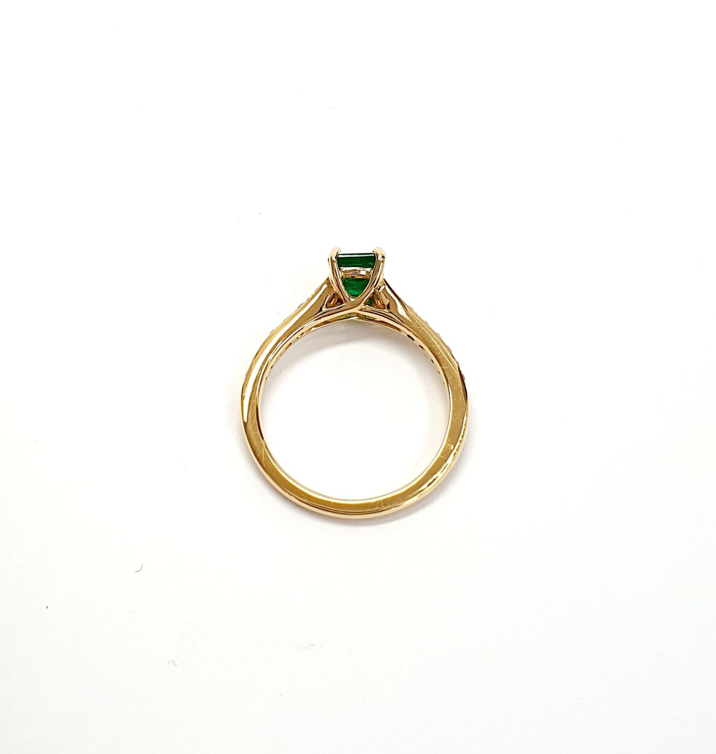 Under-gallery detail of emerald and diamond ring