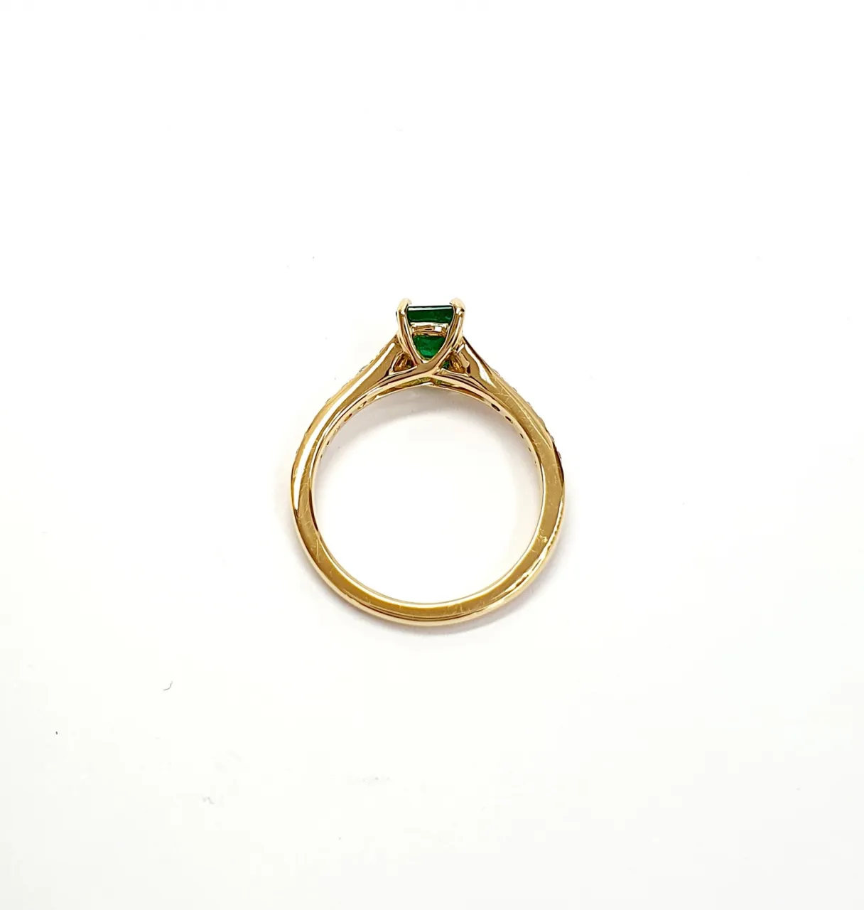 Under-gallery detail of emerald and diamond ring