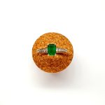 Top view of step cut emerald ring on a cork