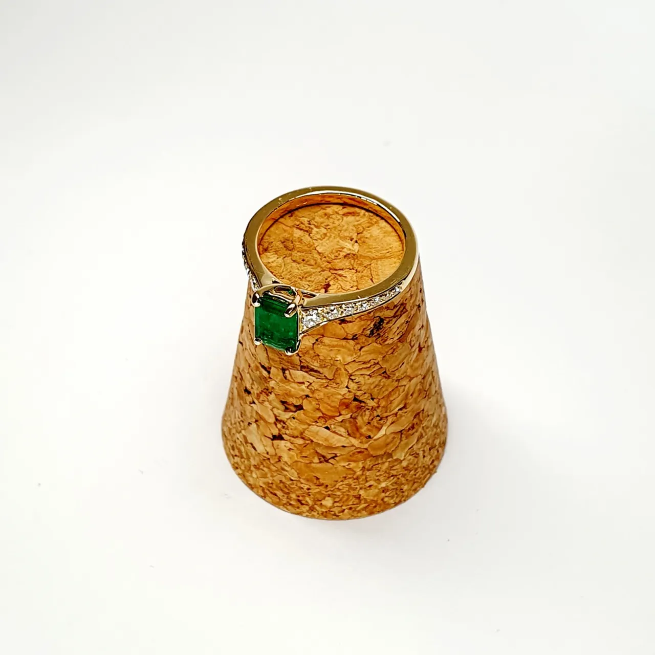 Ring posed diagonally on cork with gemstone facing left