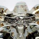 The Lambeth Platinum Diamond Engagement Ring RPT00045 The centre is set with a 0.70ct round brilliant-cut diamond of Colour H clarity SI1, which has an excellent cut, proportions, and symmetry. The side shoulders are channel set with a total of four princess-cut diamonds and four baguette-cut diamonds. The total diamond weight is 1.08 carats.