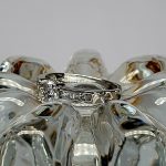 The Lambeth Platinum Diamond Engagement Ring RPT00045 The centre is set with a 0.70ct round brilliant-cut diamond of Colour H clarity SI1, which has an excellent cut, proportions, and symmetry. The side shoulders are channel set with a total of four princess-cut diamonds and four baguette-cut diamonds. The total diamond weight is 1.08 carats.