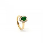 At the heart of this exquisite 18ct yellow gold ring lies a resplendent 7mm x 5mm oval emerald weighing an impressive 0.84 carats and exuding an enchanting green hue. Its captivating charm captures the essence of nature's beauty, with twelve dazzling round brilliant-cut diamonds, totalling 0.41 carats, surrounding the emerald. Each stone is meticulously selected to enhance the ring's allure with unparalleled radiance and brilliance, and the basket-wire setting measures 13mm x 10mm.RA00696.