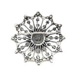 The back view of A real sterling silver starburst brooch with a single cultured pearl centre radiating a starburst of white sparkling crystals and an outer scalloped edge, BRS00098.Measures 38mm x 38mm.