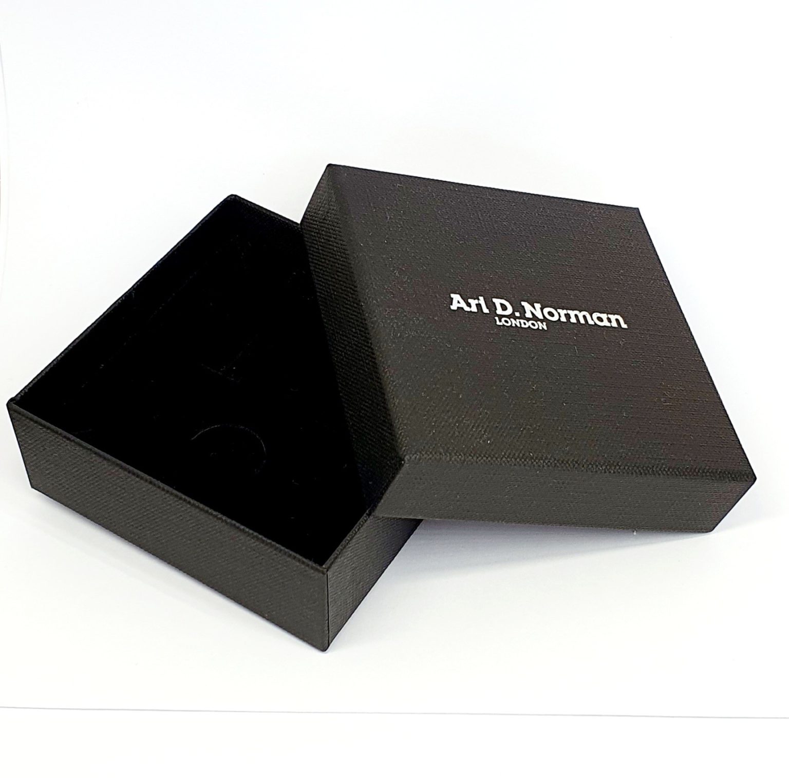 Black cardboard two part box with a black draw string pouch inside. open.