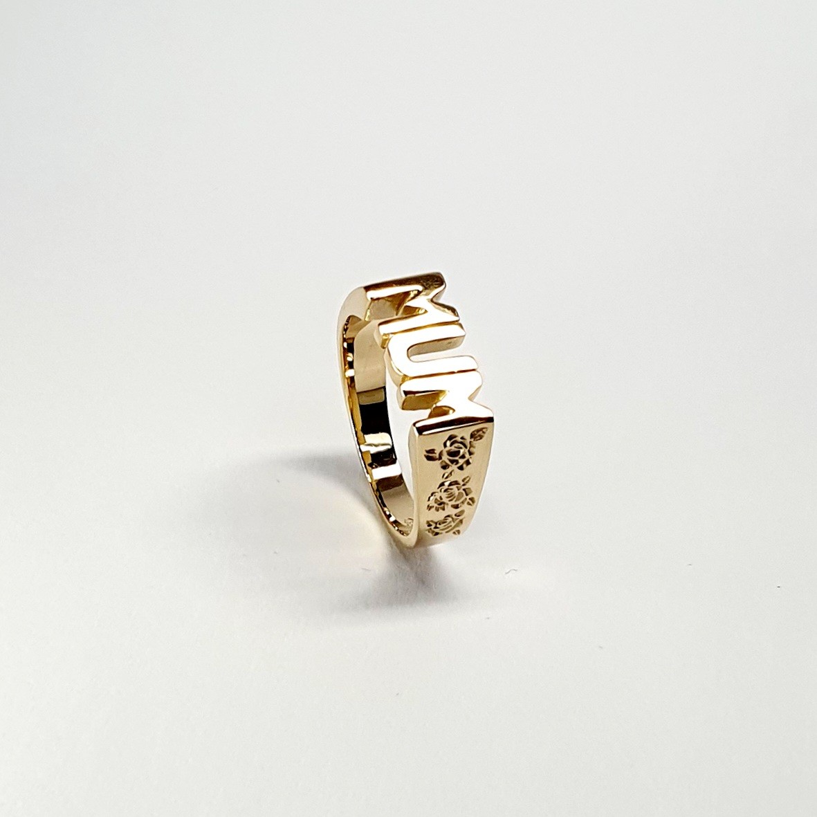 The solid 9ct yellow gold mum ring R00145 has three hand-engraved roses on each side.