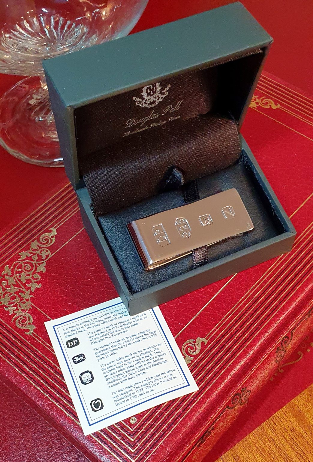 James Bond Money Clip (50mm x 18mm) has large feature hallmarks, similar to those used in a James Bond film. (Stock number MC0034) It is Picture on a red book with a hallmark description card.