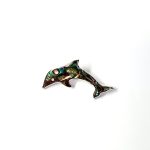 Oyster shell dolphin brooch in sterling silver. Front view.
