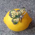 Lemon Butterfly Brooch Sterling Silver BRS00107 Genuine 925 sterling silver butterfly brooch with lemon and pale green colour Plique-à-jour enamel wings with real marcasite set to the tips, the body and eye with a golden yellow enamel with two long polished silver antennae.