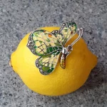 Lemon Butterfly Brooch Sterling Silver BRS00107 Genuine 925 sterling silver butterfly brooch with lemon and pale green colour Plique-à-jour enamel wings with real marcasite set to the tips, the body and eye with a golden yellow enamel with two long polished silver antennae.