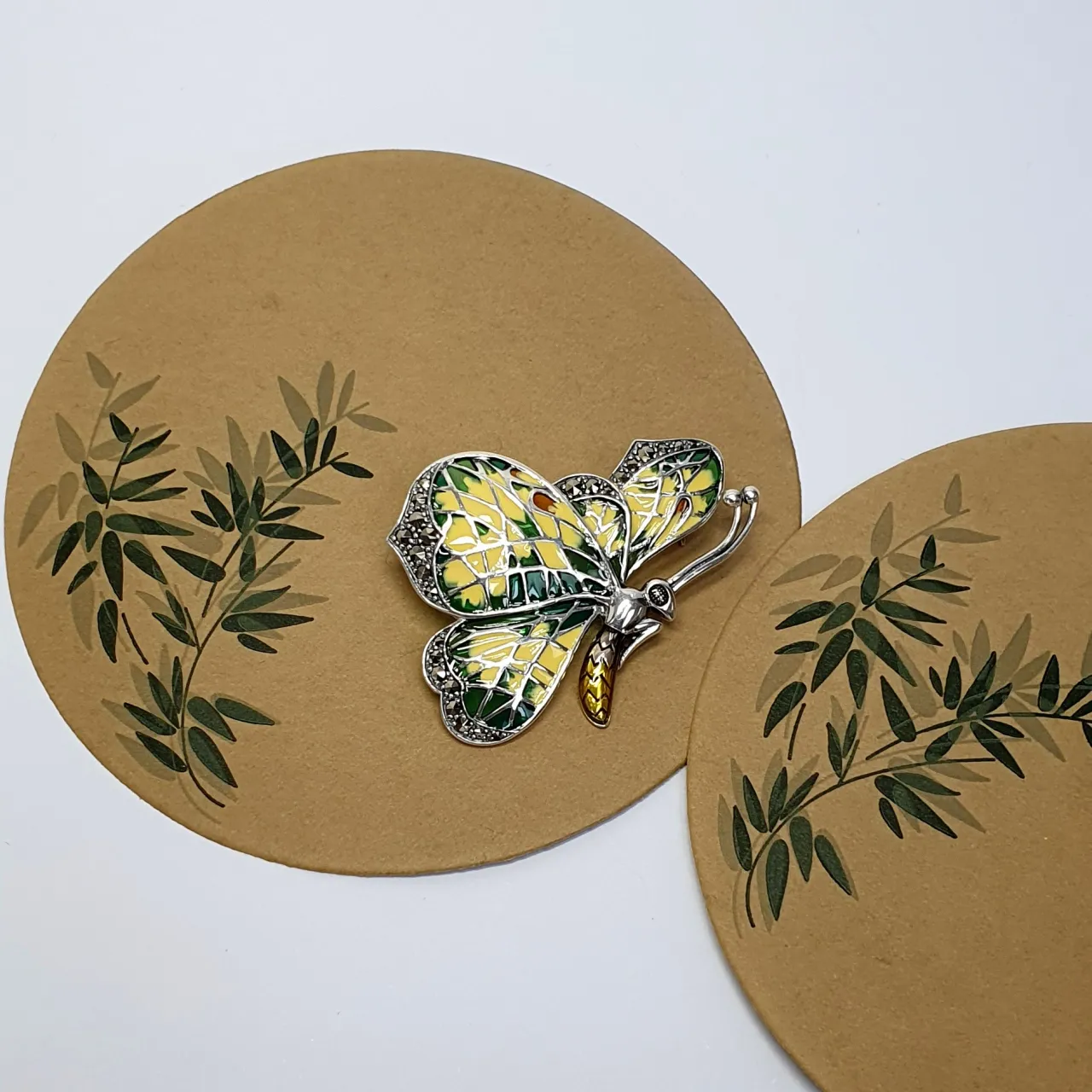 Genuine 925 sterling silver butterfly brooch with lemon and pale green colour Plique-à-jour enamel wings with real marcasite set to the tips, the body and eye with a golden yellow enamel with two long polished silver antennae