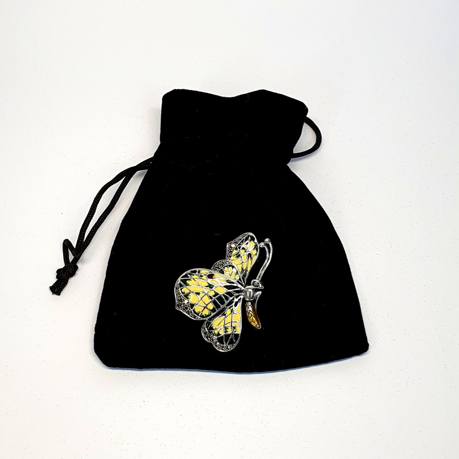 Genuine 925 sterling silver butterfly brooch with lemon and pale green colour Plique-à-jour enamel wings with real marcasite set to the tips, the body and eye with a golden yellow enamel with two long polished silver antennae.