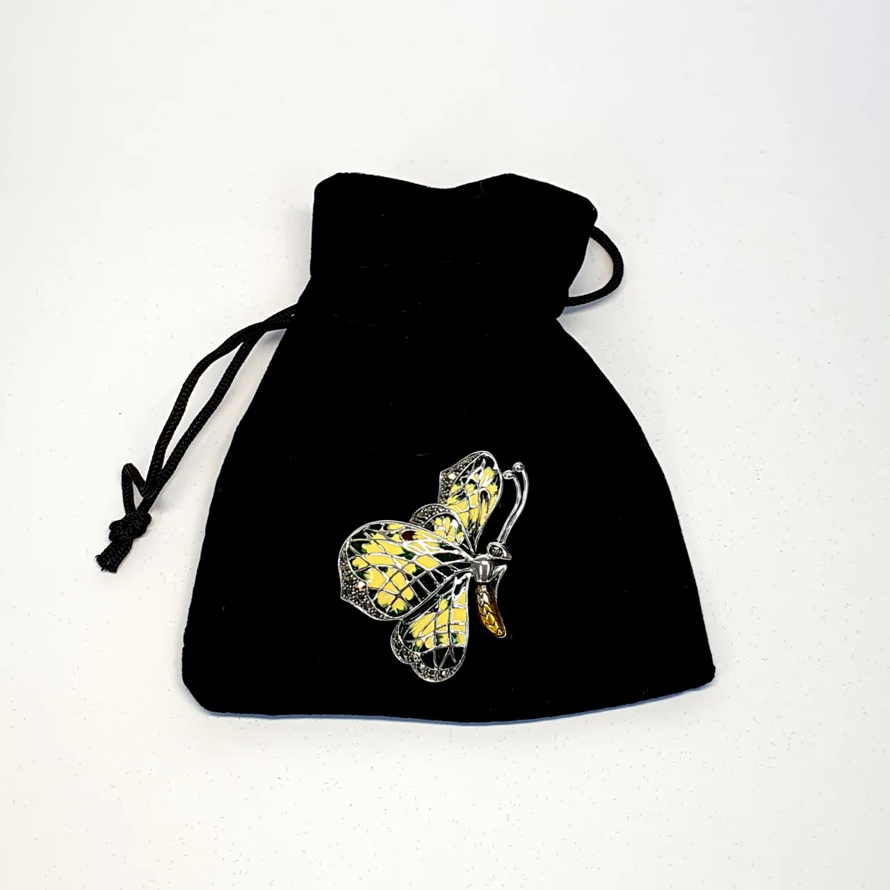 Genuine 925 sterling silver butterfly brooch with lemon and pale green colour Plique-à-jour enamel wings with real marcasite set to the tips, the body and eye with a golden yellow enamel with two long polished silver antennae.