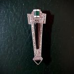 Art Deco style Brooch pin set with Black Onyx, Green Agate and Marcasite BRS00106. Front view on dark green background.