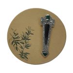 Art Deco-style Brooch pin set with Black Onyx, Green Agate, and marcasite BRS00106. Front view on beige. circle with green leaf's to the left side. green leaf