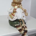 Gold expanding baby bangle 5mm wide with a diamond cut pattern BBG0003 shown in between the legs of a toy mouse that looks like an elf