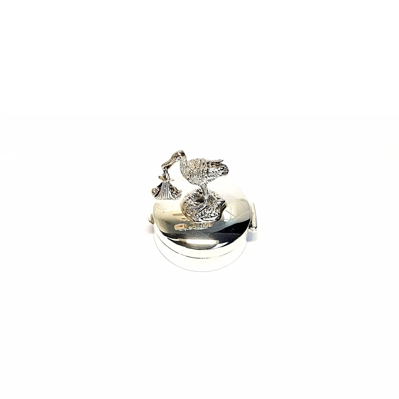 Hallmarked Silver round-hinged pill box with a 3D stork and a baby standing on the lid facing to the left view from the top.