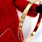 9ct gold small adjustable baby bangle with embossed pictures of toys BBG0004