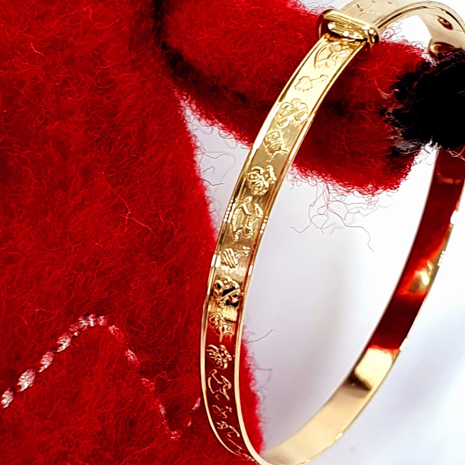 9ct gold small adjustable baby bangle with embossed pictures of toys BBG0004