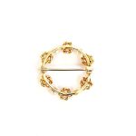A 9ct yellow gold circle brooch of six 3.8mm pearls & six gold double knots alternately equally spaced in a circle, picture shows back view.