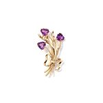 Crafted in 9ct yellow gold with three stems of purple amethyst hearts as flowers with leaves & a golden bow