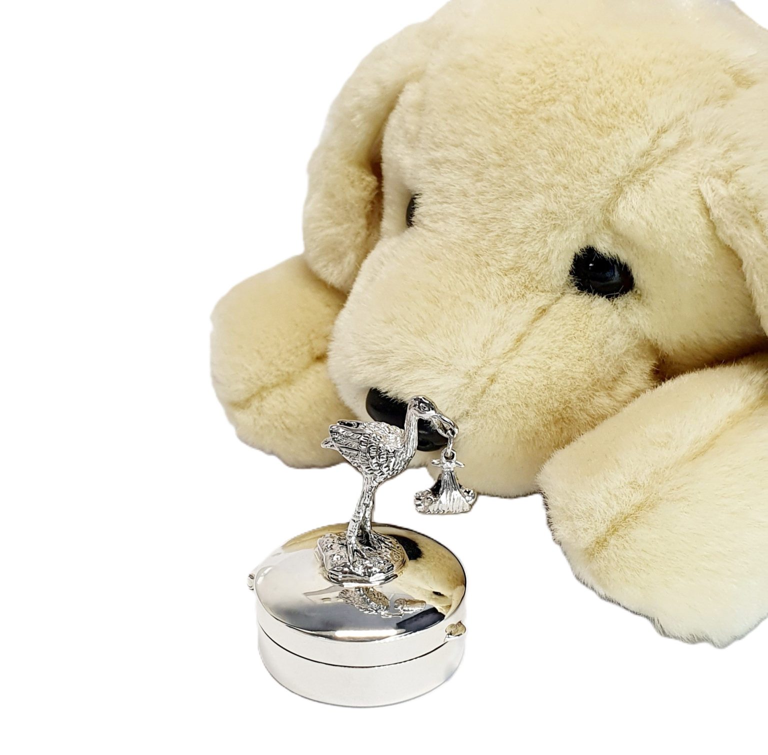 Round-hinged trinket box with a 3D stork standing on the lid facing to the right .