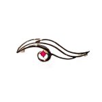 This unusual brooch is crafted in 9ct yellow gold in the shape of the eye of Horus with a single red ruby iris. Front view.