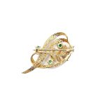 9ct yellow gold brooch with a sprig of seven leaves coming through a floral swirl of polished and barked yellow gold with three bright green emeralds & three sparkling diamonds set into a small white rhodium section, view of the back.