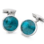 Close up of round blue silver cufflinks.