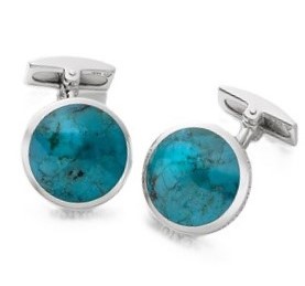 Close up of round blue silver cufflinks.