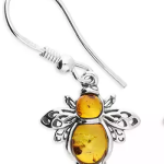 The Wimborne genuine silver Baltic honey colour amber honey bee drop earrings close up.
