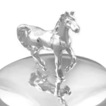 A petite round polished silver trinket box with a cantering horse on the top of the hinged lid.