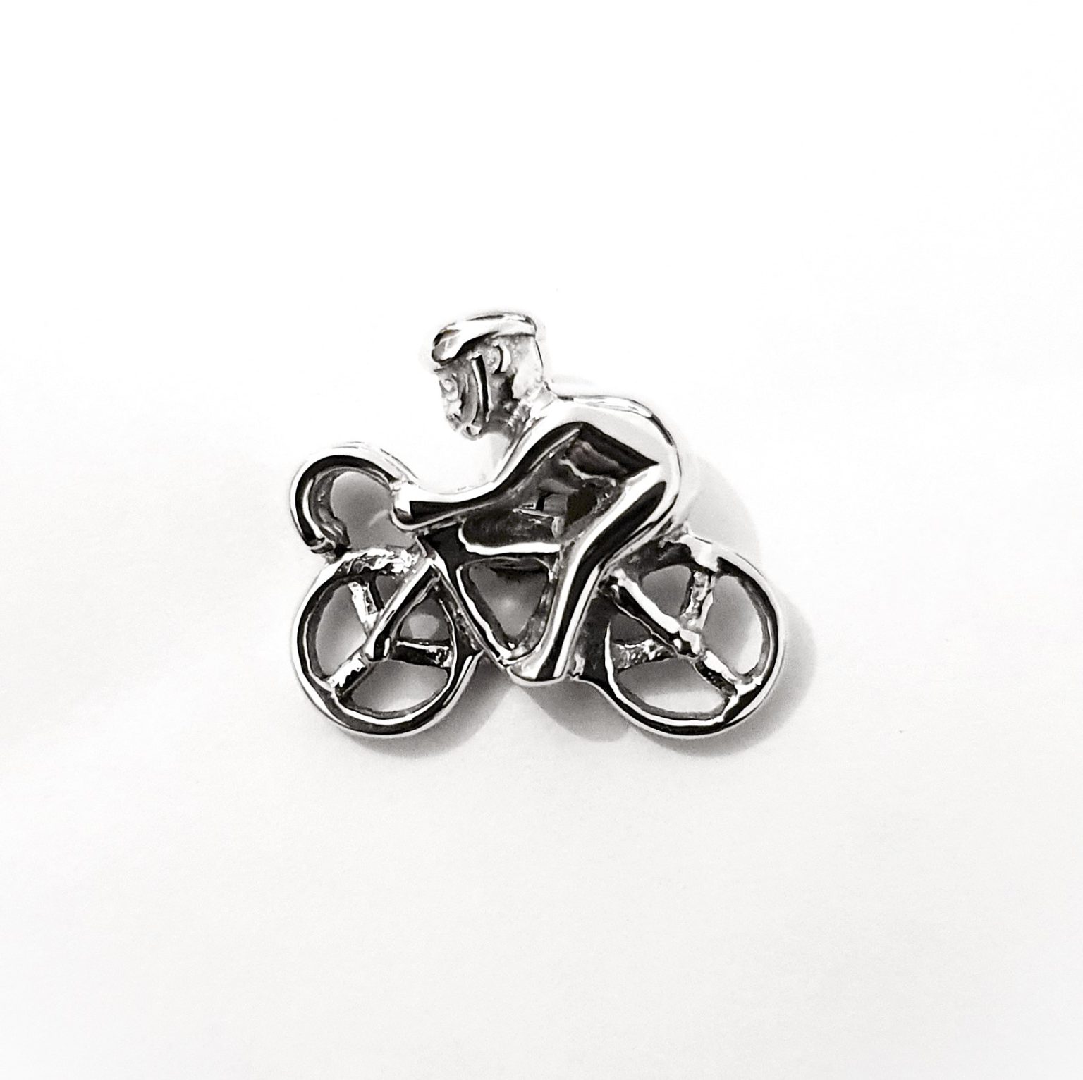 A striking pair of sterling silver cufflinks a carved racing cyclist on a bike with a helmet.