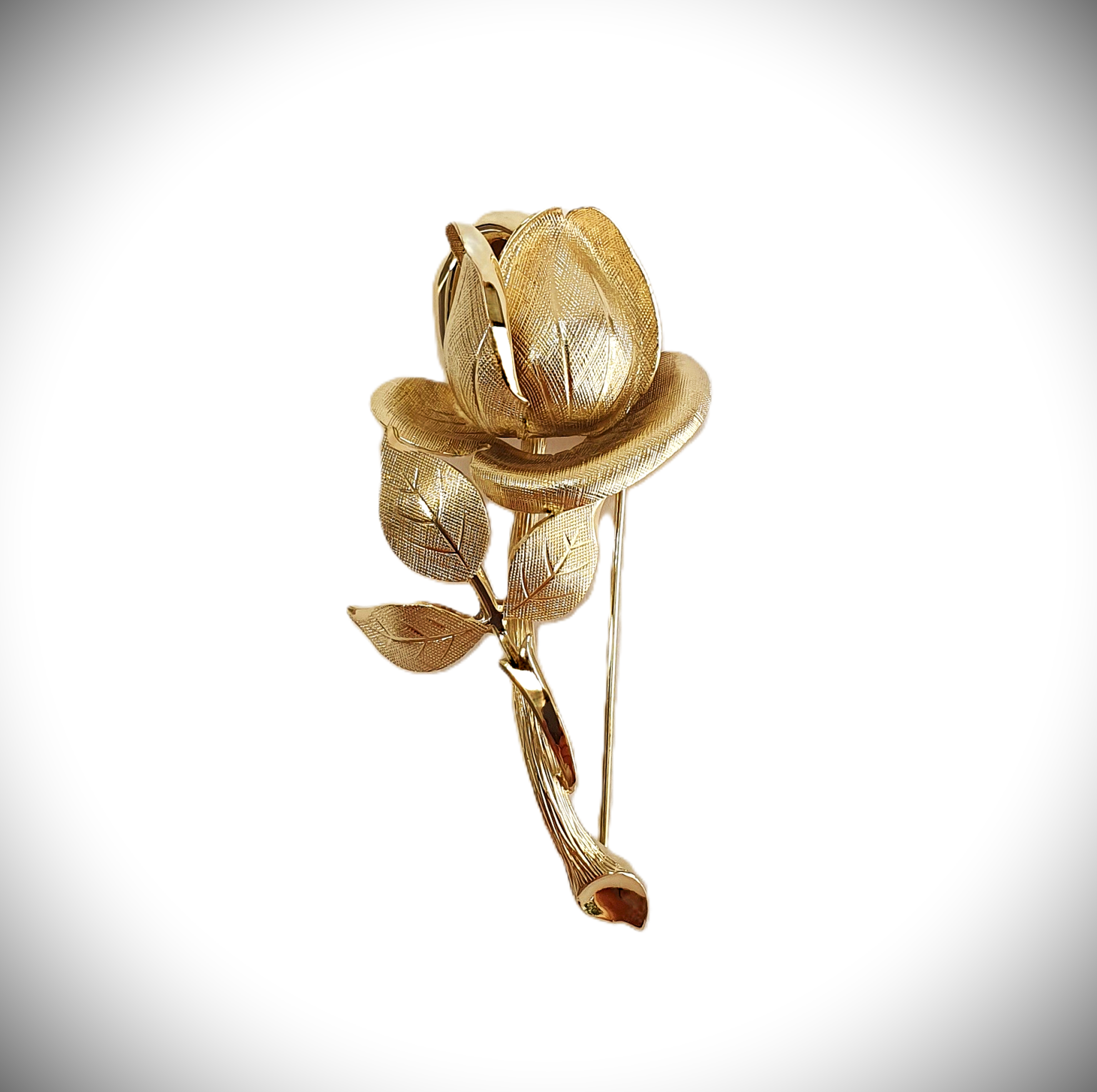 9ct yellow gold single rose broch with a textured pattern with polished highlights.