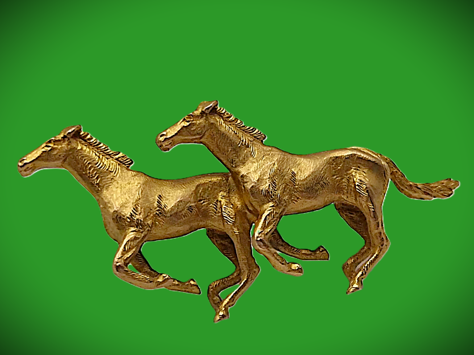 This is a superb brooch by one of the best makers, Alabaster & Wilson. Two galloping horses are side by side, and the detail screams quality pictured on a green background.