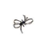 Front View "The Cropp & Farr 18ct white-gold brooch, featuring seven round sapphires and forty-one diamonds, elegantly arranged in a bow design. Stock number: BRQ00050."