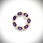 Seven round, beautiful cultured pearls with a further seven alternating stunning oval amethyst gemstones all set into a 9ct yellow gold circle wreath design brooch.