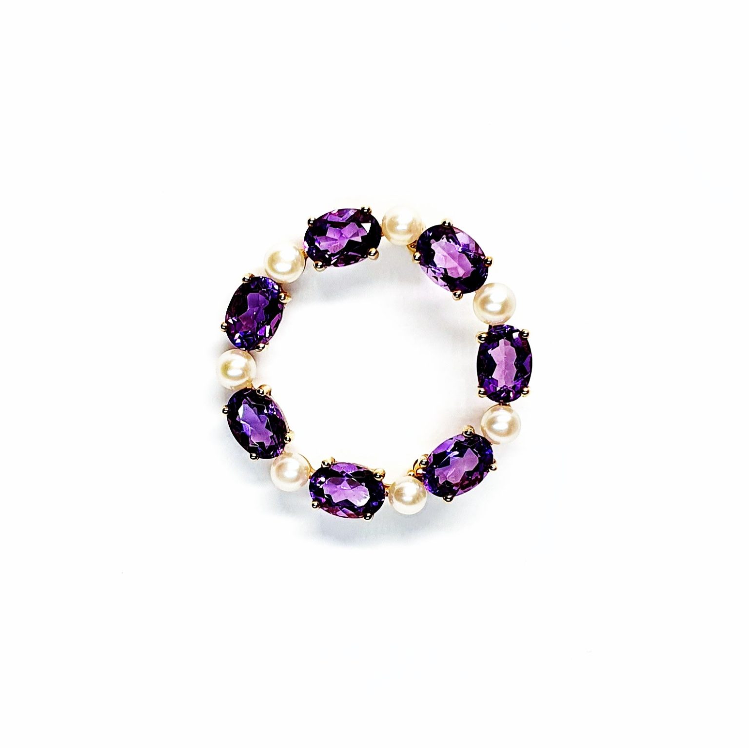 Seven round, beautiful cultured pearls with a further seven alternating stunning oval amethyst gemstones all set into a 9ct yellow gold circle wreath design brooch.
