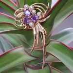 Beautiful multiple gold ribbon brooch set with five round pearls and three stunning round purple amethyst gemstones.