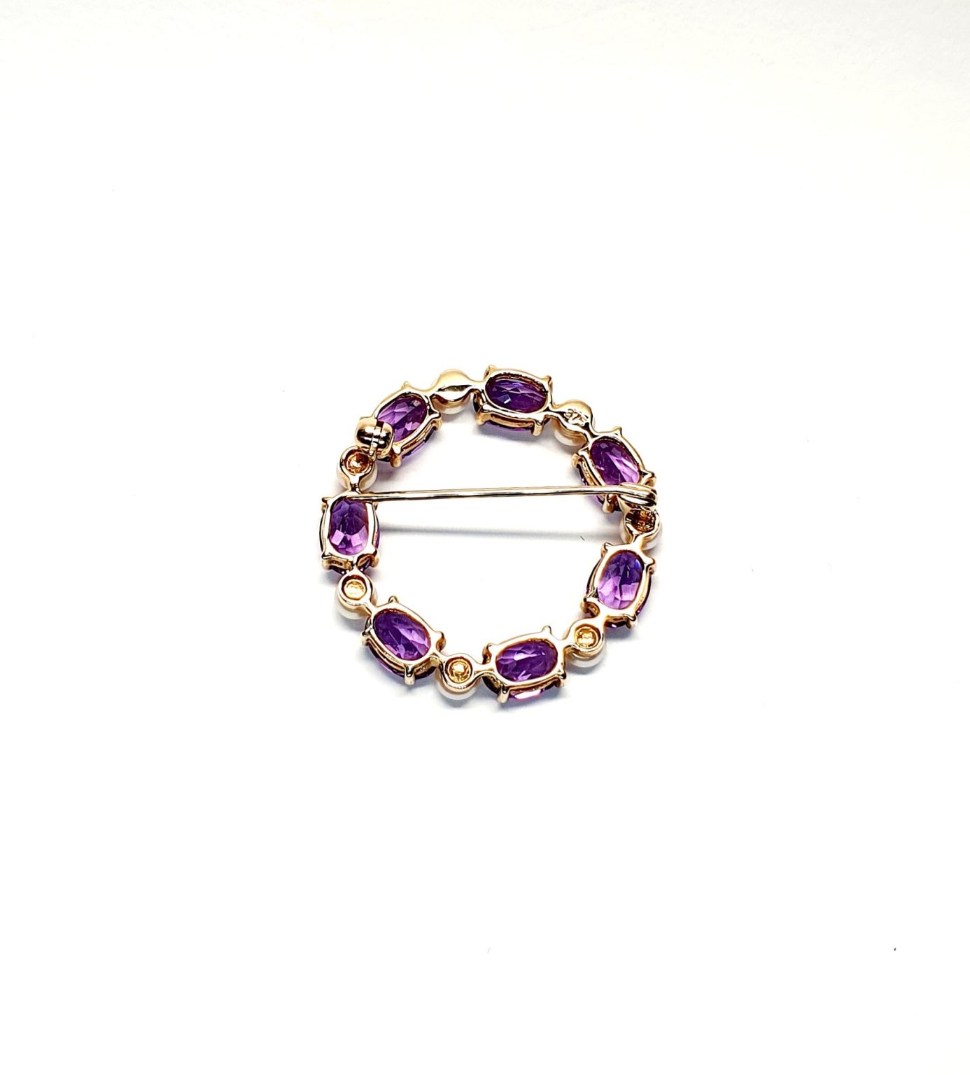 Seven round, beautiful cultured pearls with a further seven alternating stunning oval amethyst gemstones all set into a 9ct yellow gold circle wreath design brooch. Back view.