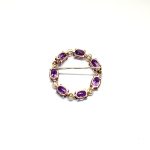 Seven round, beautiful cultured pearls with a further seven alternating stunning oval amethyst gemstones all set into a 9ct yellow gold circle wreath design brooch. Back view.