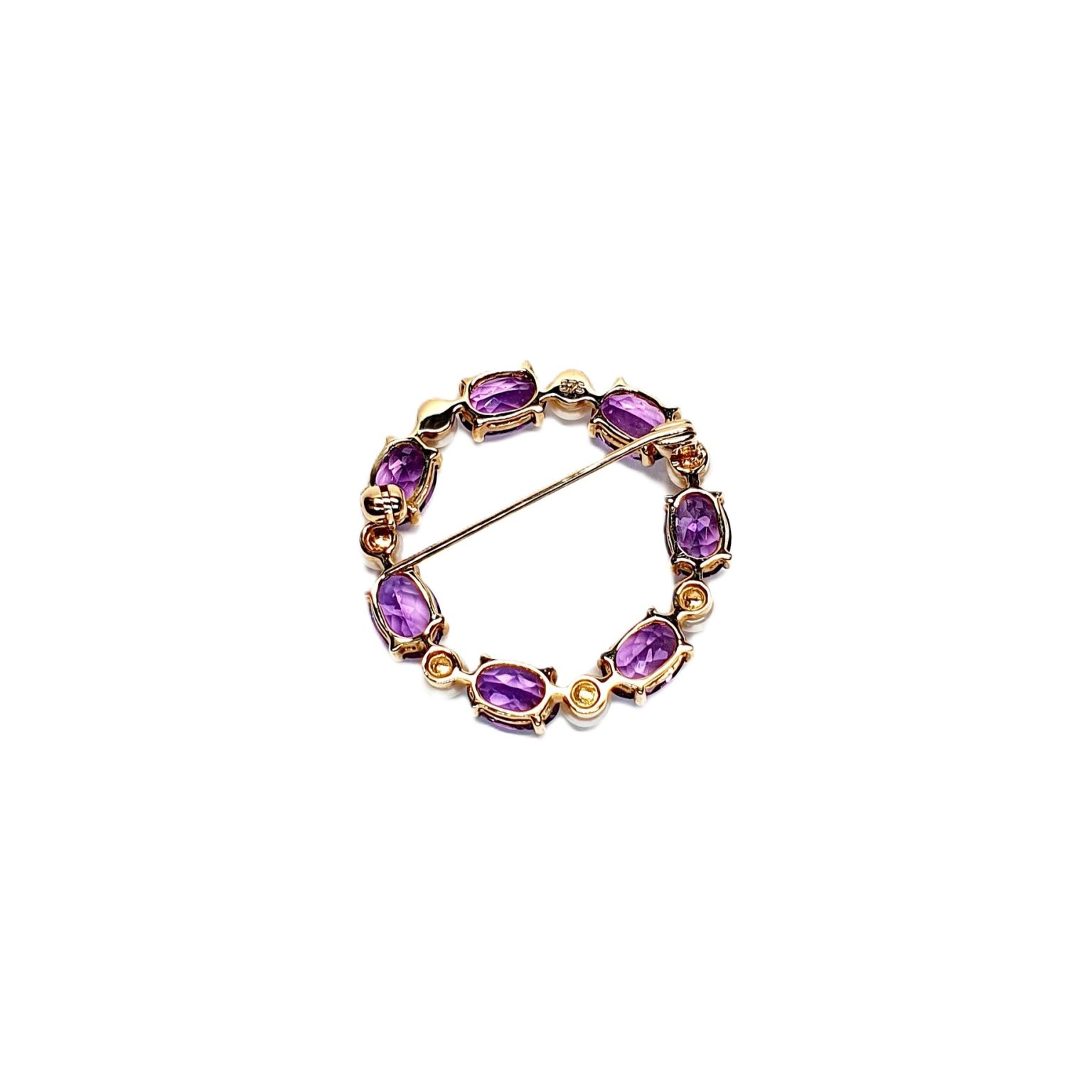 Seven round, beautiful cultured pearls with a further seven alternating stunning oval amethyst gemstones all set into a 9ct yellow gold circle wreath design brooch. View from the back.