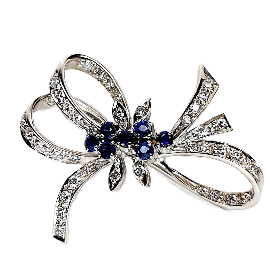 Enlarged Close-Up View "A close-up view of the Cropp & Farr 18ct white-gold brooch, showcasing the intricate craftsmanship and vibrant sapphires and diamonds. Stock number: BRQ00050."
