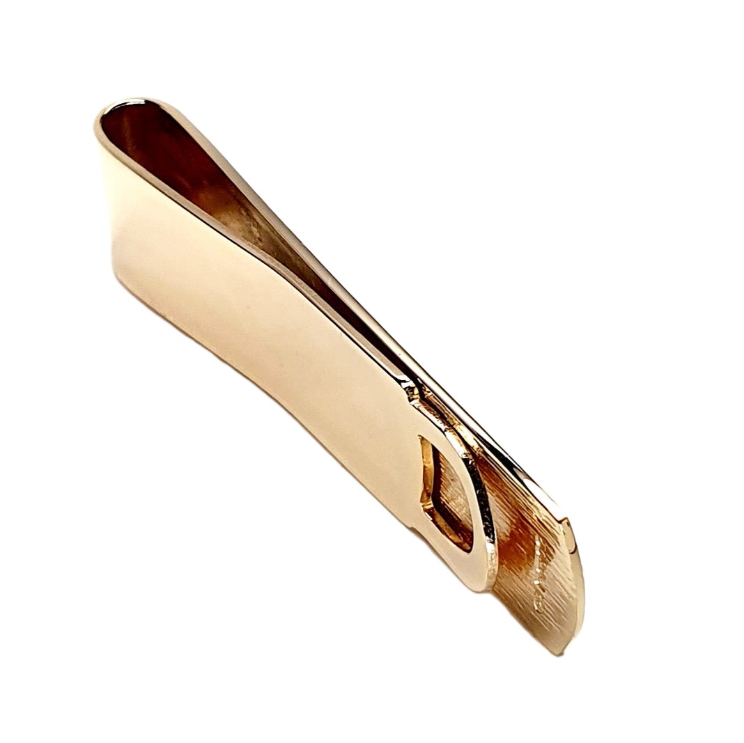A handmade 9ct Gold Money Clip with a polished back and a hand-engraved tree bark pattern to the front. London hallmarked, it comes in a stylish black leatherette box with a black velvet pad and a white silk inner lid.