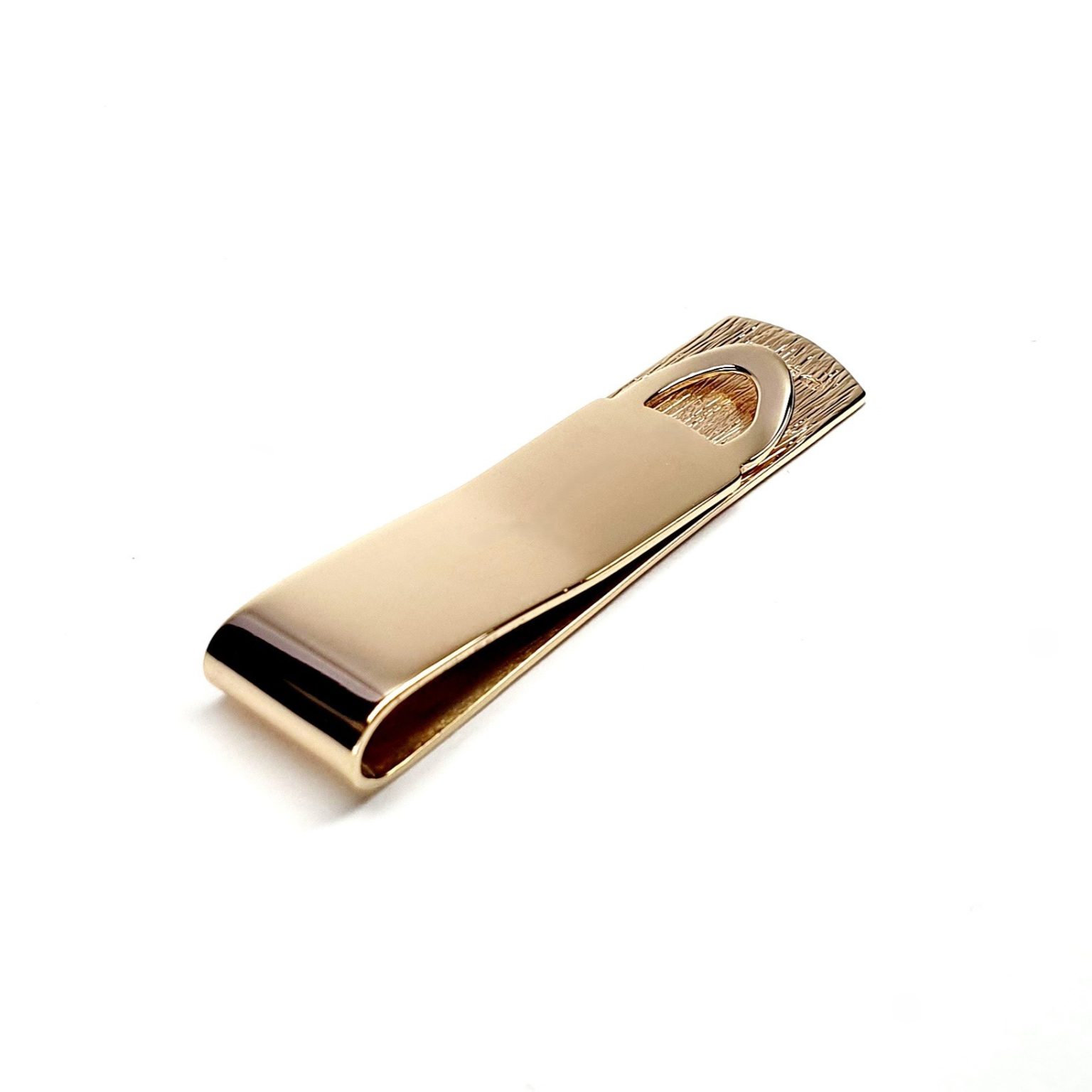 A handmade 9ct Gold Money Clip with a polished back and a hand-engraved tree bark pattern to the front. London hallmarked, it comes in a stylish black leatherette box with a black velvet pad and a white silk inner lid.