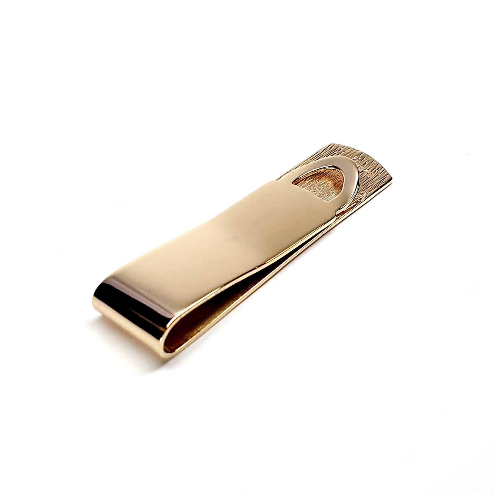 A handmade 9ct Gold Money Clip with a polished back and a hand-engraved tree bark pattern to the front. London hallmarked, it comes in a stylish black leatherette box with a black velvet pad and a white silk inner lid.