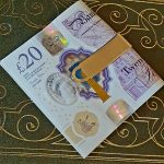 Gold money clip with a unique tree bark pattern, ideal as a gift.