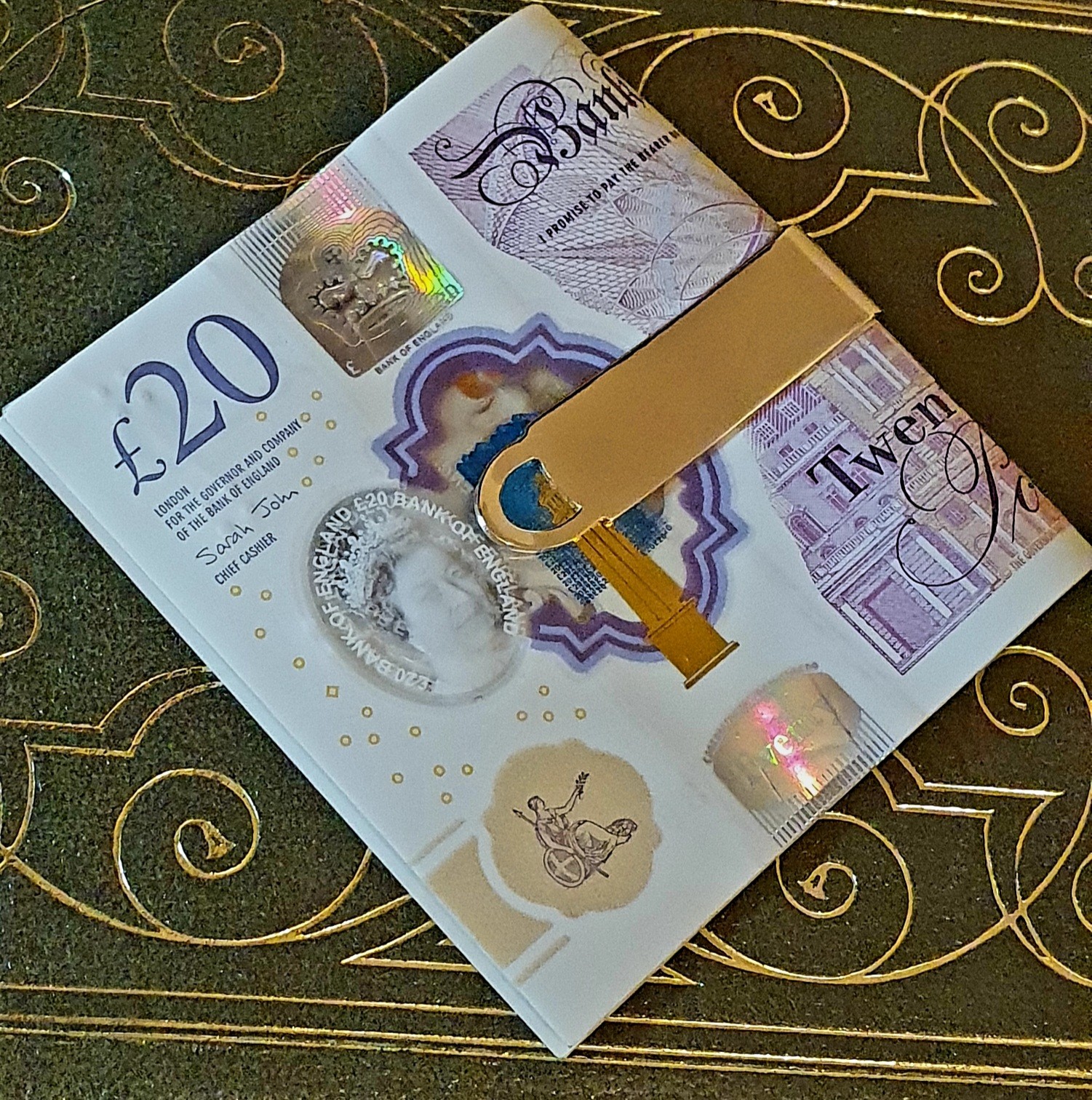 Gold money clip with a unique tree bark pattern, ideal as a gift.