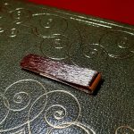 Gold clip for your notes with a unique tree bark pattern, ideal as a gift pictured on a twenty-pound note.
